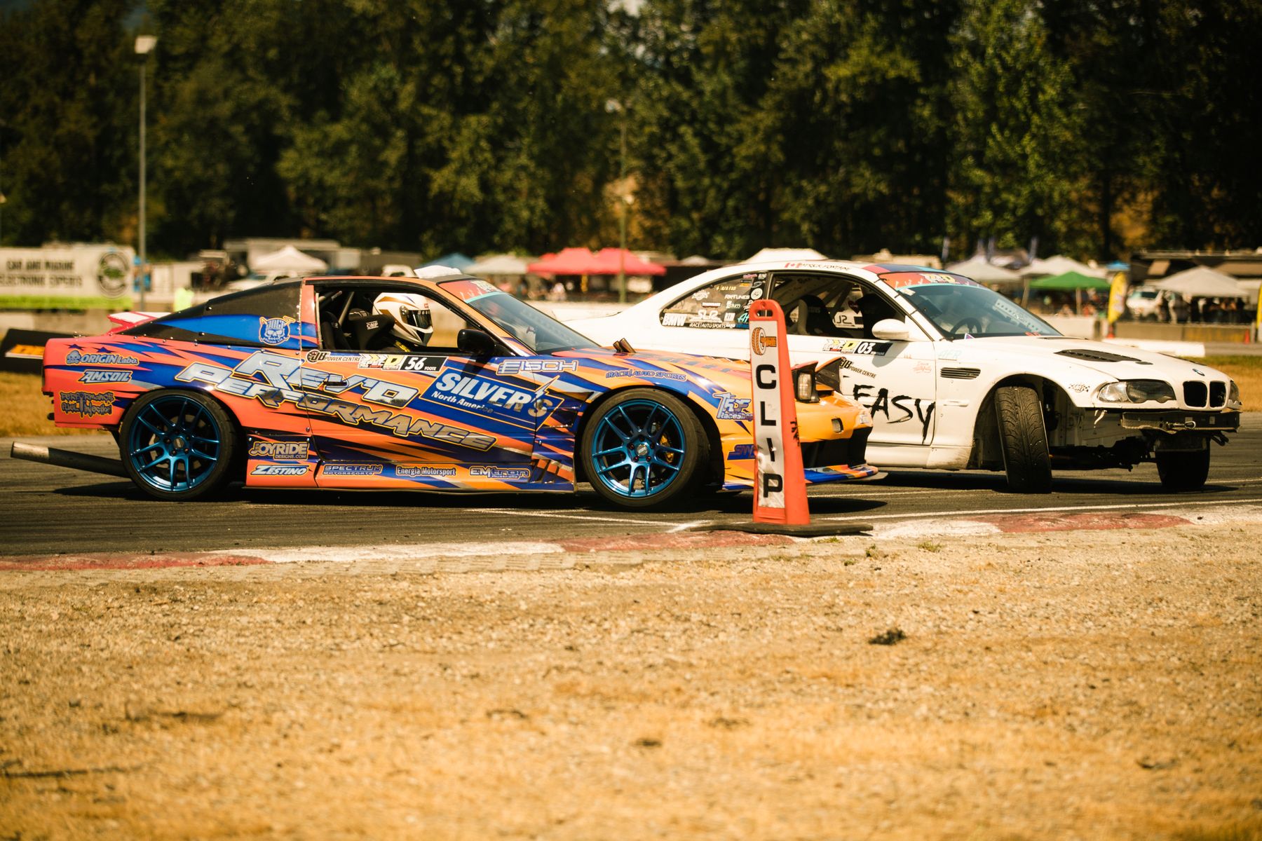 Sports cars drifting at speed on a race track in Canada