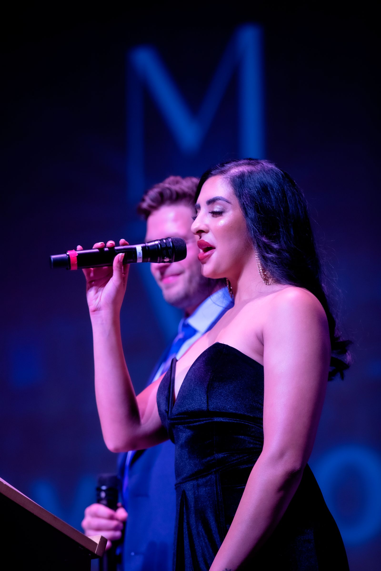 Artist performing under vivid stage lighting