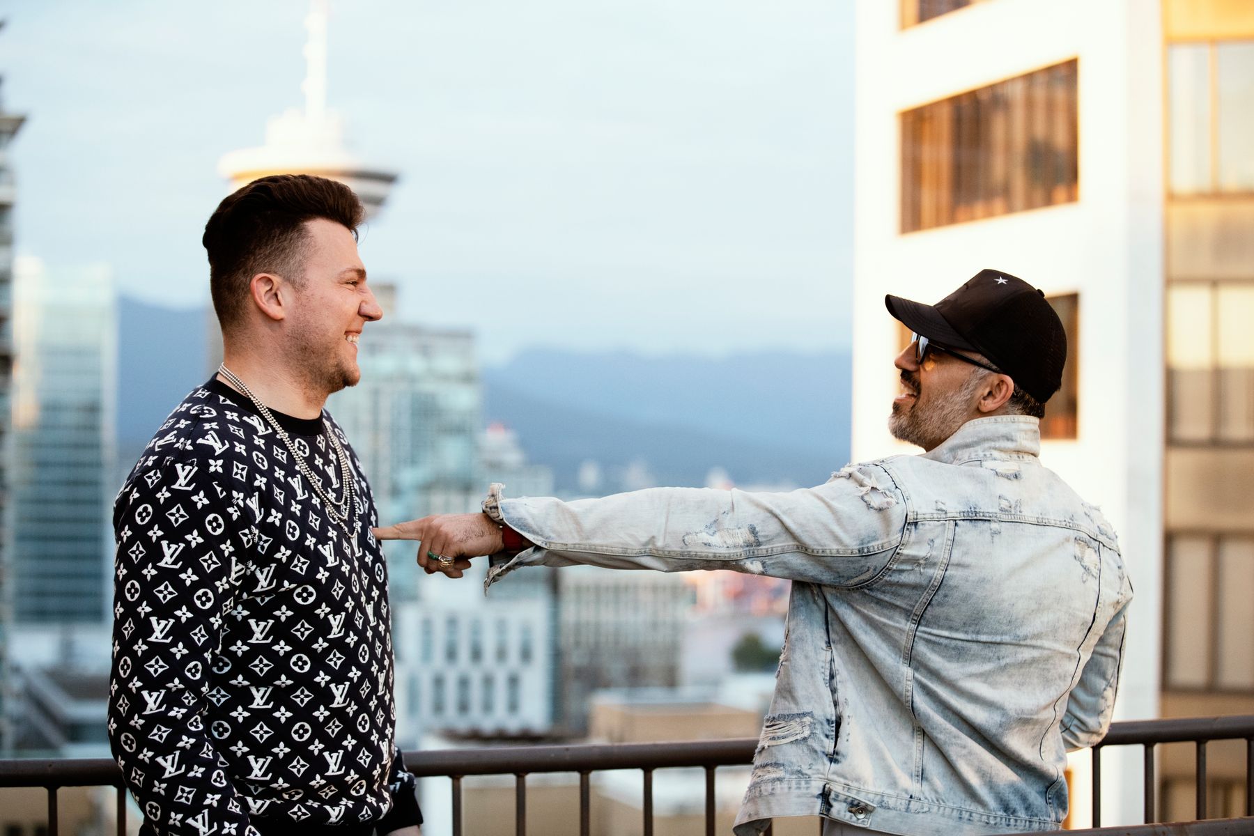 Two artists sharing a candid moment on a Toronto rooftop